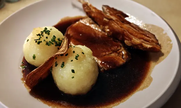 Crispy schweinebraten, beer sauce and grated potato dumplings.
